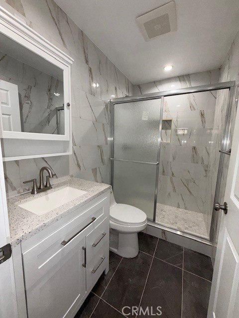 18419 Tuba Street Northridge, CA 91325 - Photo 8 of 15 a bathroom with a granite countertop sink toilet and shower