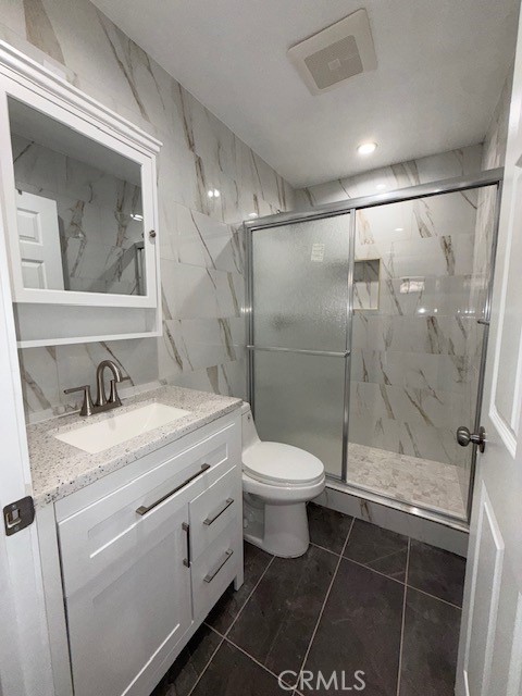 18419 Tuba Street Northridge, CA 91325 - Photo 9 of 15 a bathroom with a granite countertop sink toilet and shower