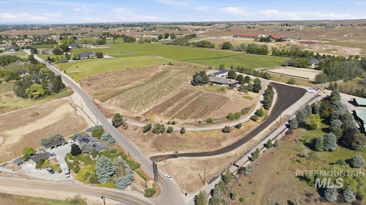 6323 Foothill Road Star, ID 83669 - Photo 38 of 50 Expansive rural landscape featuring a private vineyard, multiple residential structures, established roadways, and open fields under a clear sky