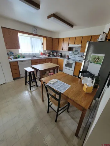 a kitchen with a table and chairs in it