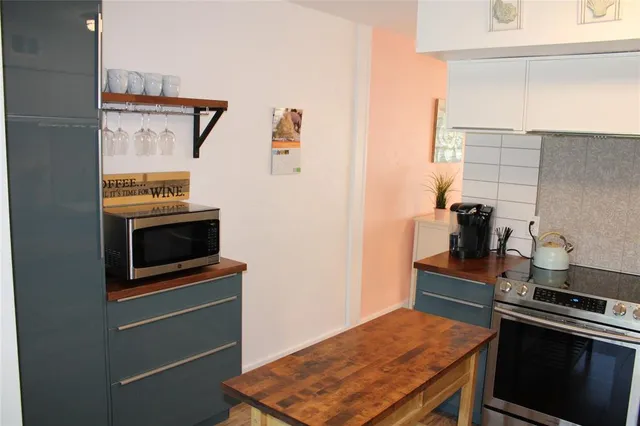 a kitchen with a sink appliances and cabinets