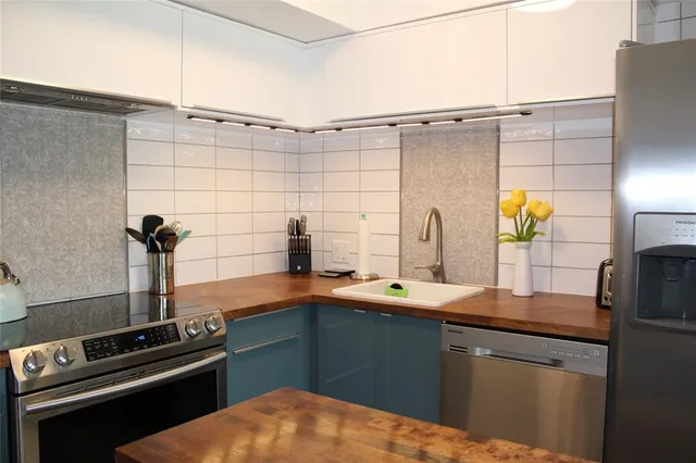 a kitchen with a refrigerator and a sink