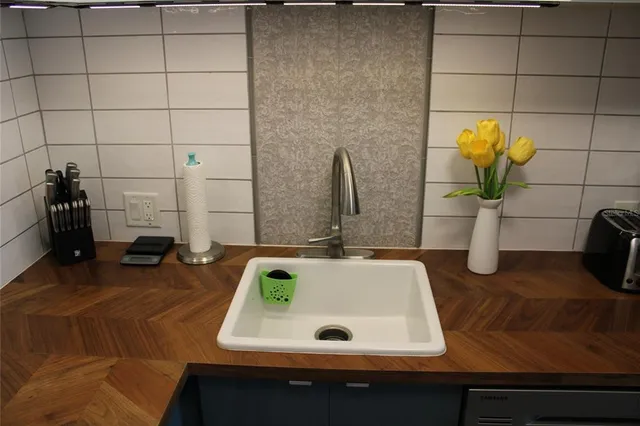 a bathroom with a stove and a wooden floor