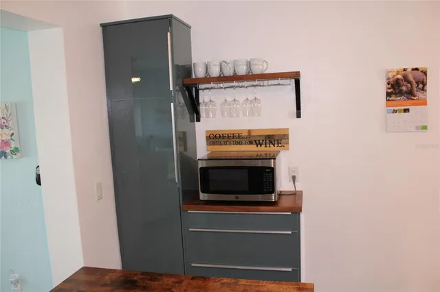 a kitchen with stainless steel appliances granite countertop a refrigerator and a stove