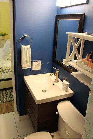 a bathroom with a toilet sink and mirror