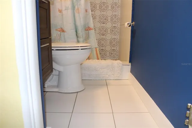 a bed room with a bed and a chandelier