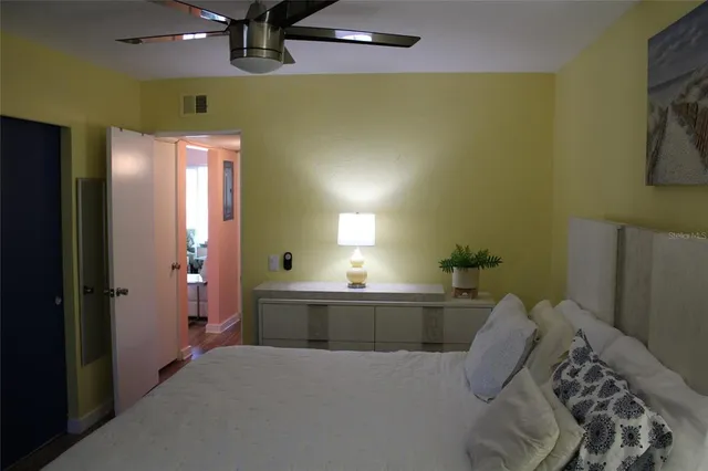a view of a hallway and a livingroom with furniture