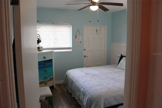 a bedroom with a bed and painting on the wall
