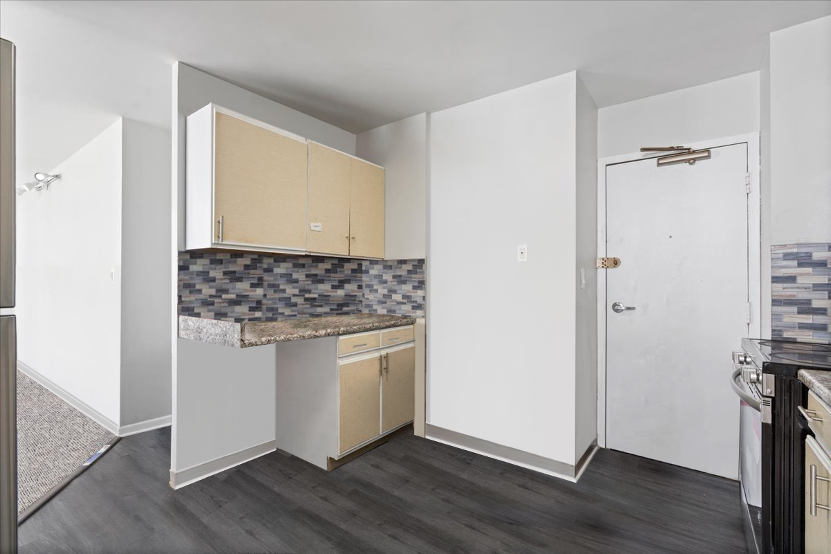 6171 North Sheridan Road, Unit 1112 Chicago, IL 60660 - Photo 9 of 23 a room with wooden floor and white walls