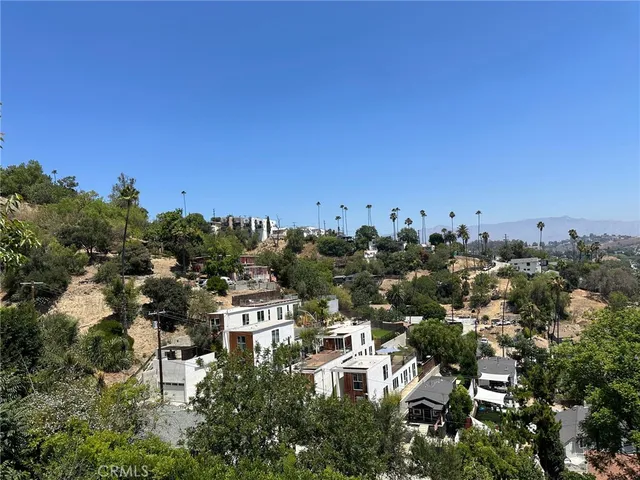 an aerial view of mountain with trees around