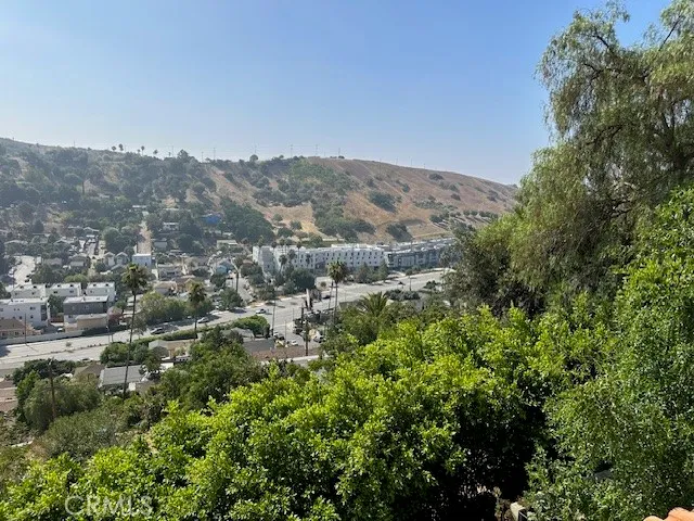 a view of backyard with small cabin and wooden fence