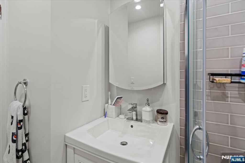 436 Undercliff Avenue, Unit 1 Edgewater, NJ 07020 - Photo 12 of 16 a bathroom with a sink and a mirror