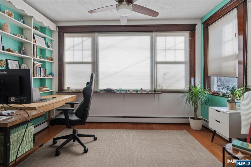 436 Undercliff Avenue, Unit 1 Edgewater, NJ 07020 - Photo 2 of 16 a workspace with furniture and a window