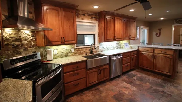 a kitchen with a sink stove and cabinets