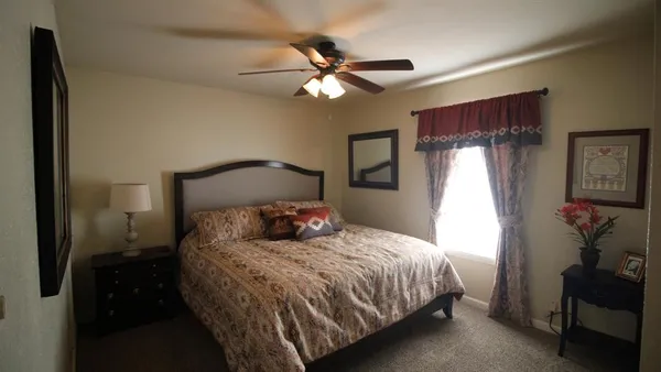 a bedroom with a bed and a chandelier