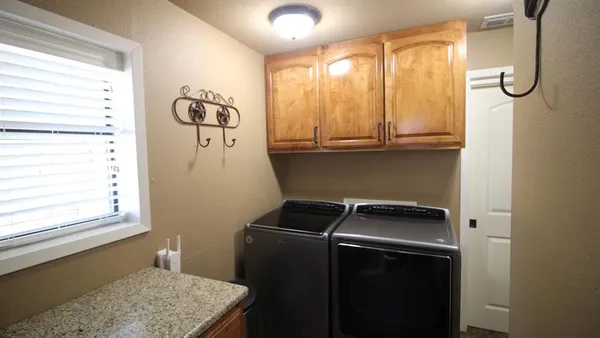 a utility room with window dryer and washer
