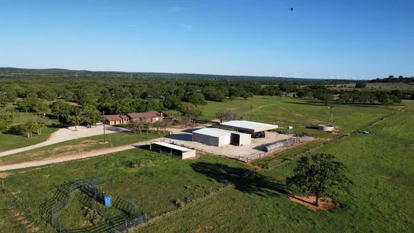 an aerial view of a house with a yard