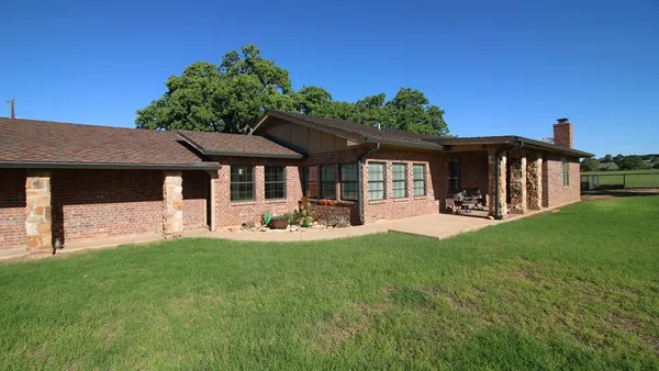 a front view of a house with a garden and porch