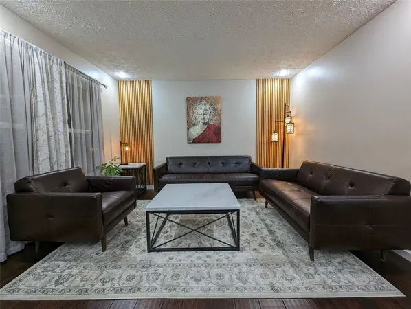 a living room with furniture and a rug