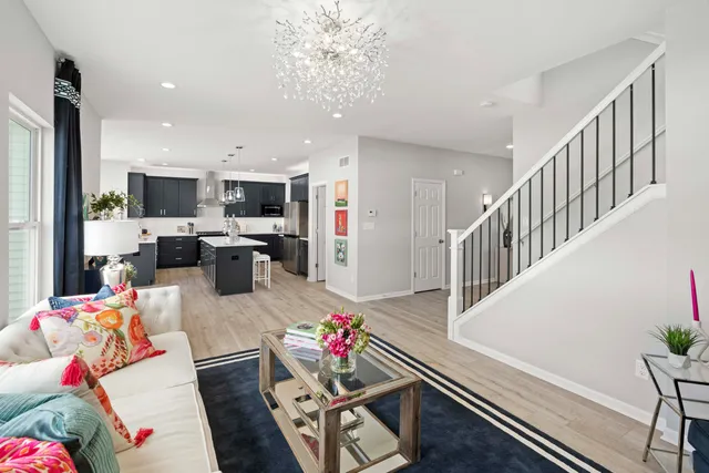 a living room with furniture fireplace and a view of kitchen