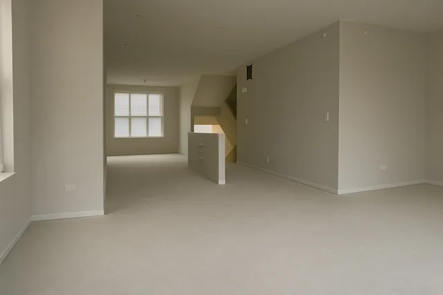 a view of an empty room with a fireplace