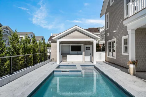 a bedroom with a bed a couch and potted plant