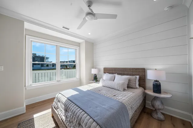 a bedroom with a bed and a large window