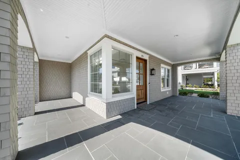 a view of entryway with wooden floor and windows
