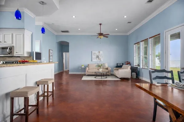 a living room with furniture and kitchen view