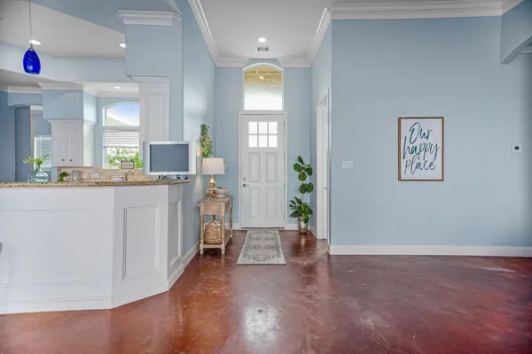 a living room with furniture a rug and a table