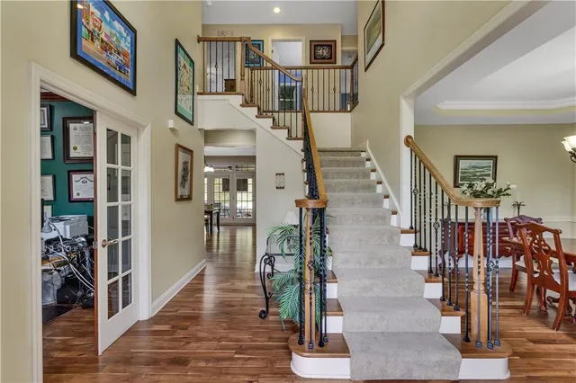 a view of entryway and hall with wooden floor
