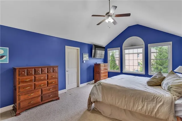 a bedroom with a bed dresser and a window