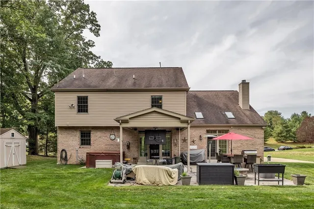 a front view of a house with a yard table and chairs