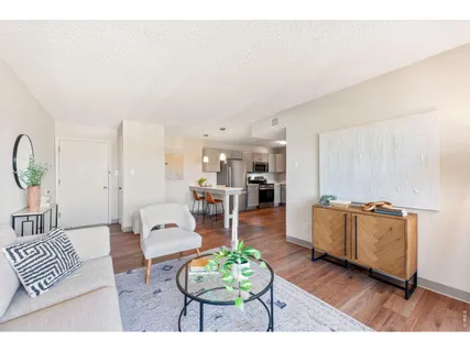 a kitchen with a refrigerator cabinets and wooden floor