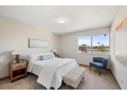 a bedroom with a bed and a painting on the wall