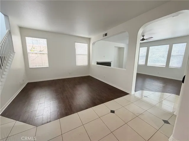 a view of a livingroom with wooden floor and a large window