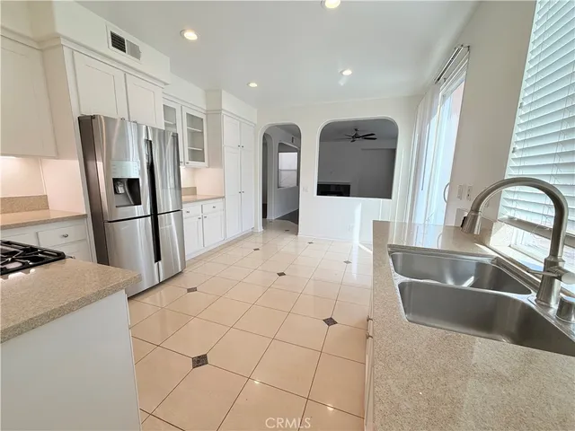 a kitchen with stainless steel appliances granite countertop a refrigerator and a sink