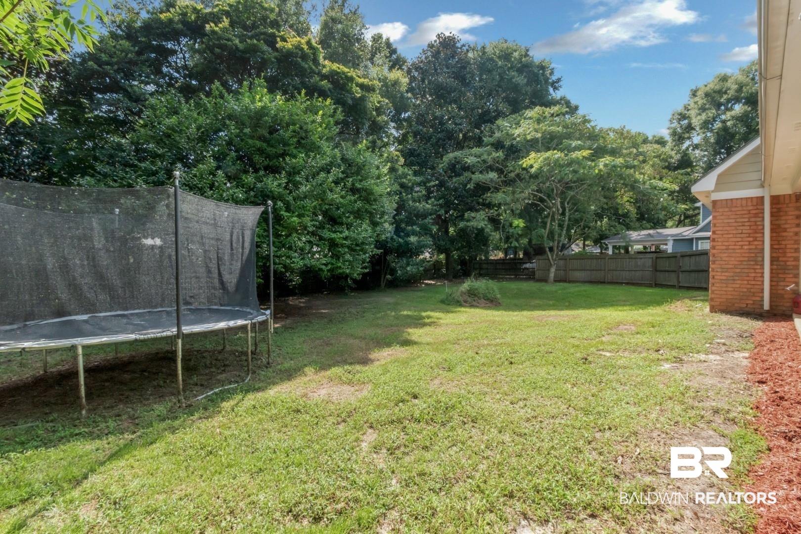 9991 Wedgefield Court Mobile, AL 36608 - Photo 29 of 30 View of yard with a trampoline