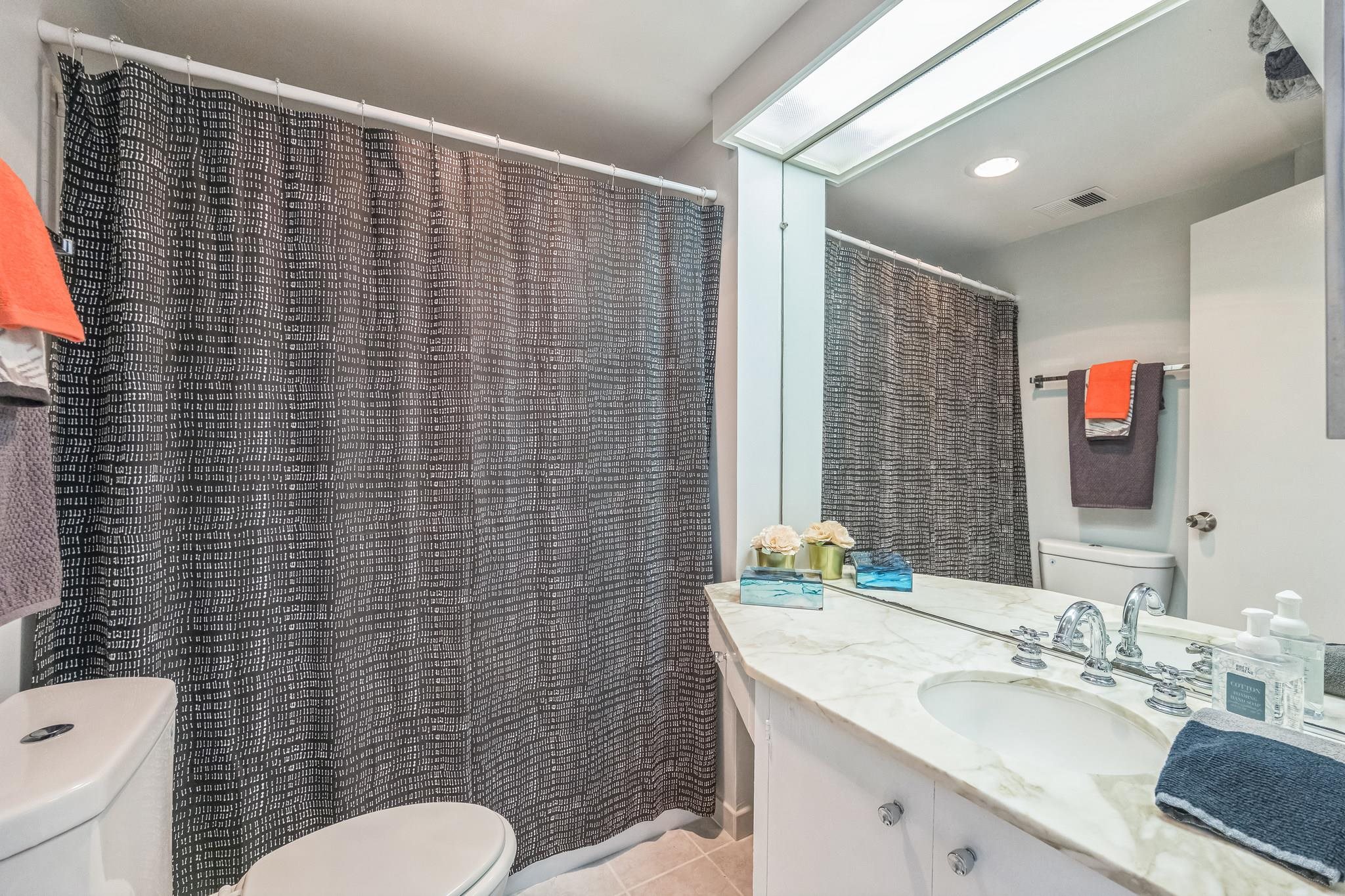 2550 Dana Street, Unit 2F Berkeley, CA 94704 - Photo 15 of 32 a bathroom with a granite countertop sink toilet and mirror