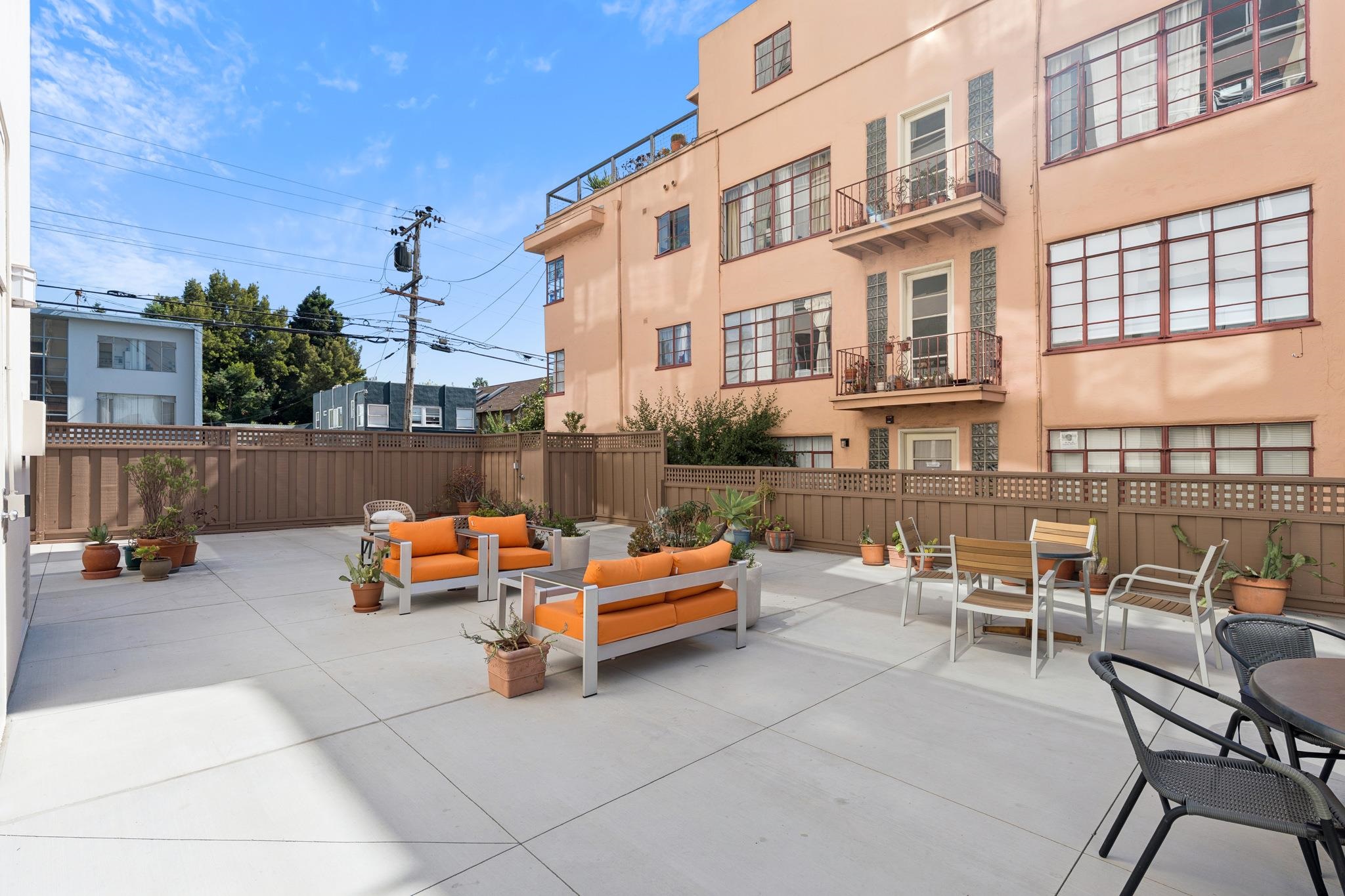 2550 Dana Street, Unit 2F Berkeley, CA 94704 - Photo 19 of 32 an outdoor sitting area with a table and chairs