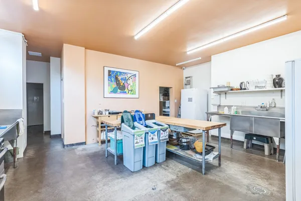 a kitchen with a table chairs sink and stainless steel appliances