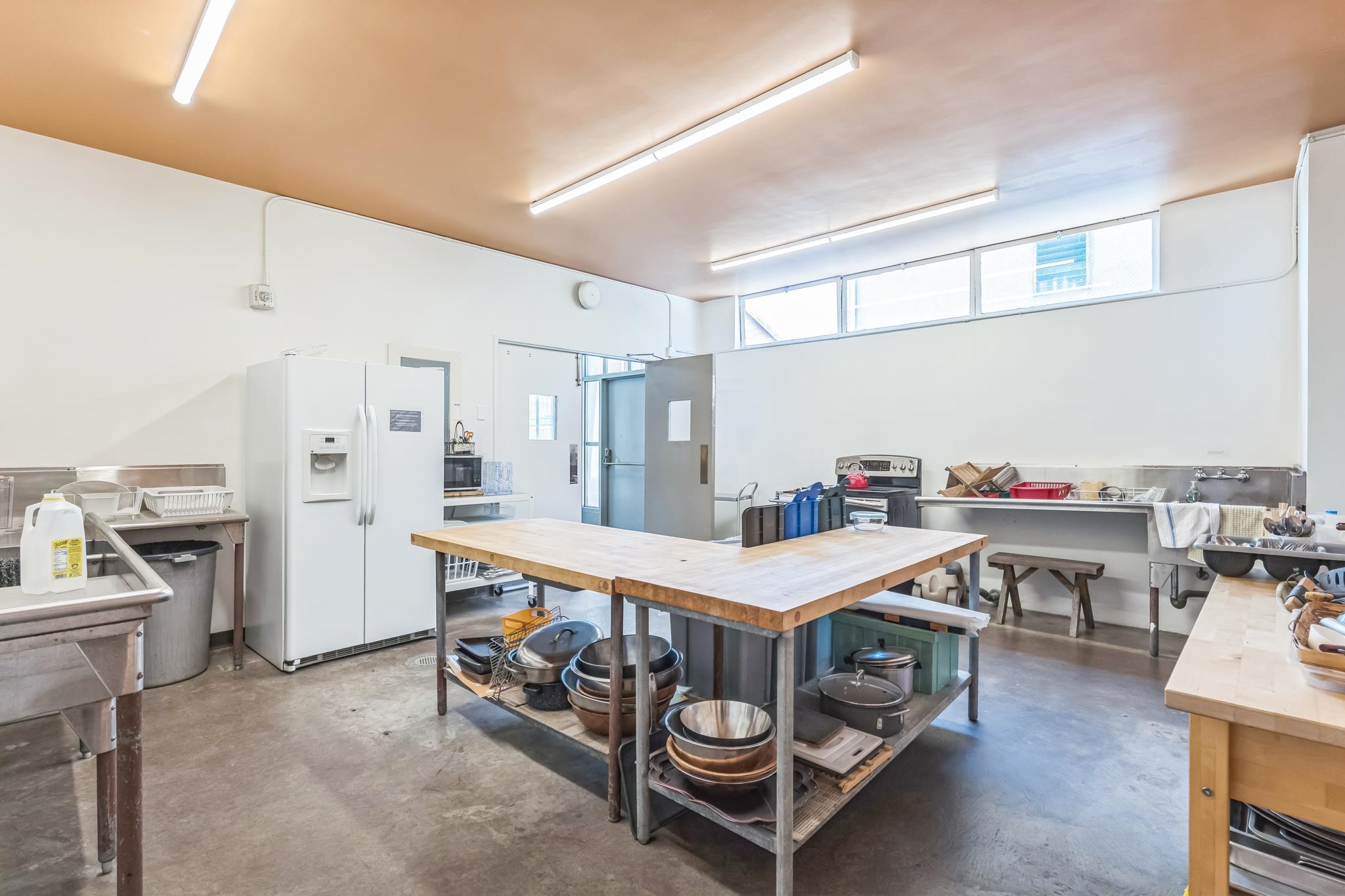 2550 Dana Street, Unit 2F Berkeley, CA 94704 - Photo 29 of 32 a kitchen with a table chairs sink and stainless steel appliances