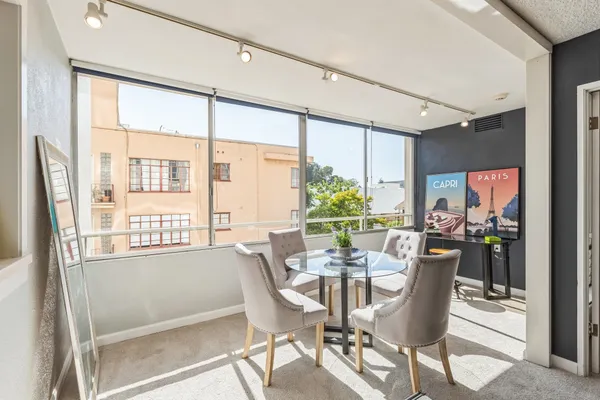 a dining room with furniture and window