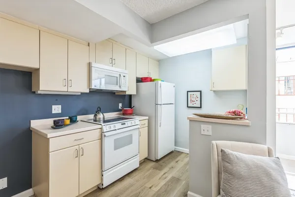 a kitchen with a white cabinets and white appliances