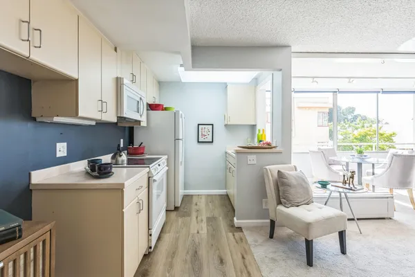 a kitchen with stainless steel appliances granite countertop a stove and a refrigerator