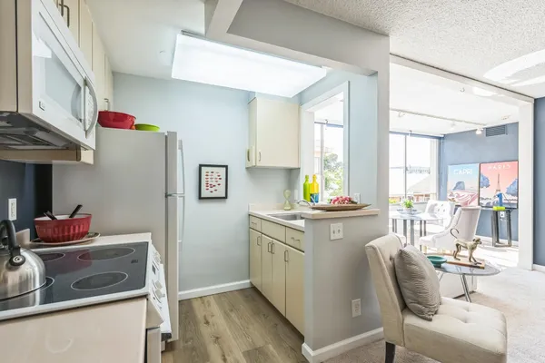 a utility room with cabinets washer and dryer