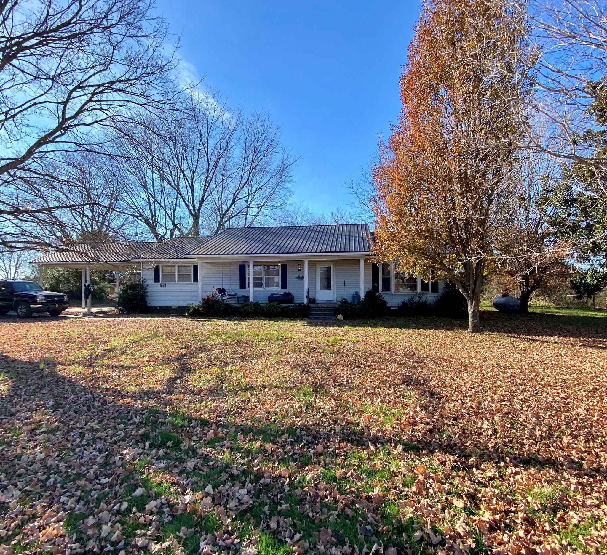 1071 Baugh Road Ardmore, TN 38449 - Photo 1 of 16 a front view of a house with a yard and trees