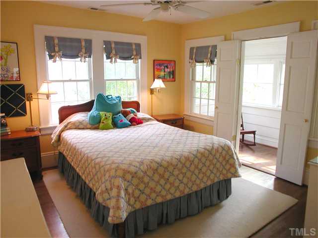 2234 The Circle Raleigh, NC 27608 - Photo 9 of 12 a bed sitting in a bedroom next to a window