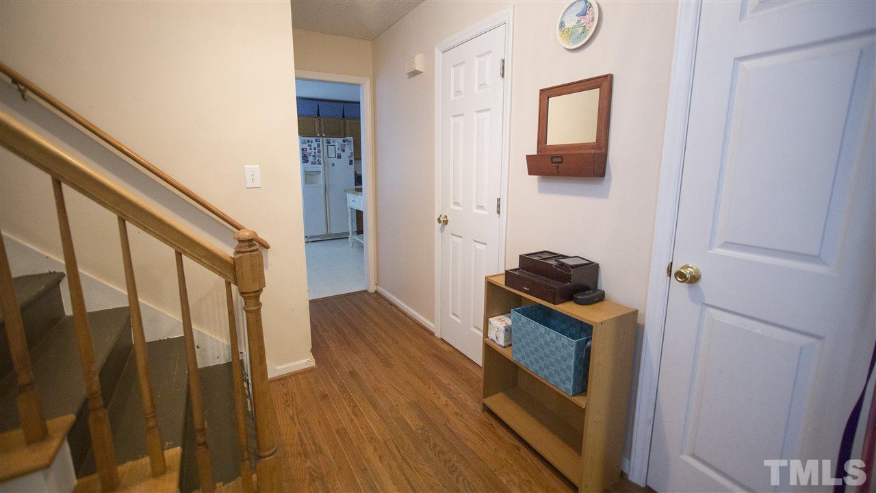 2829 Pinehurst Drive Raleigh, NC 27604 - Photo 3 of 16 a view of a hallway with wooden floor and staircase