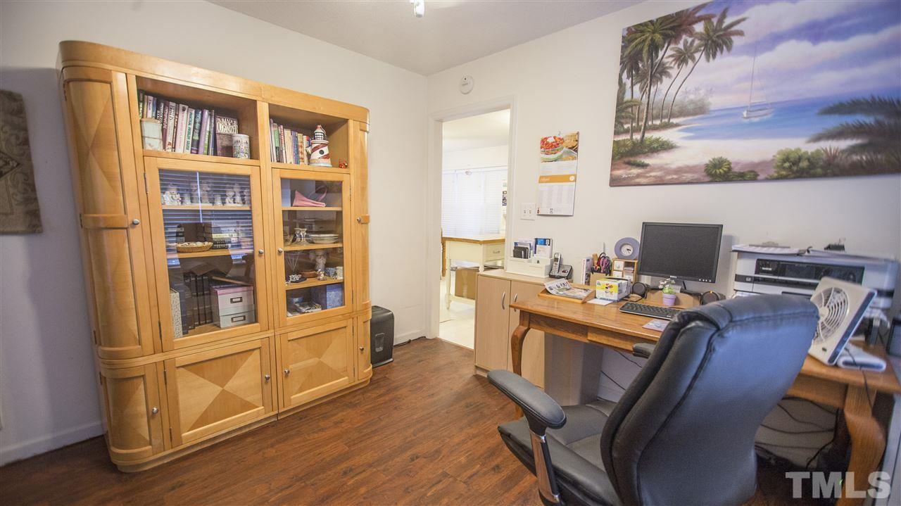 2829 Pinehurst Drive Raleigh, NC 27604 - Photo 6 of 16 a view of a workspace with furniture and cabinet